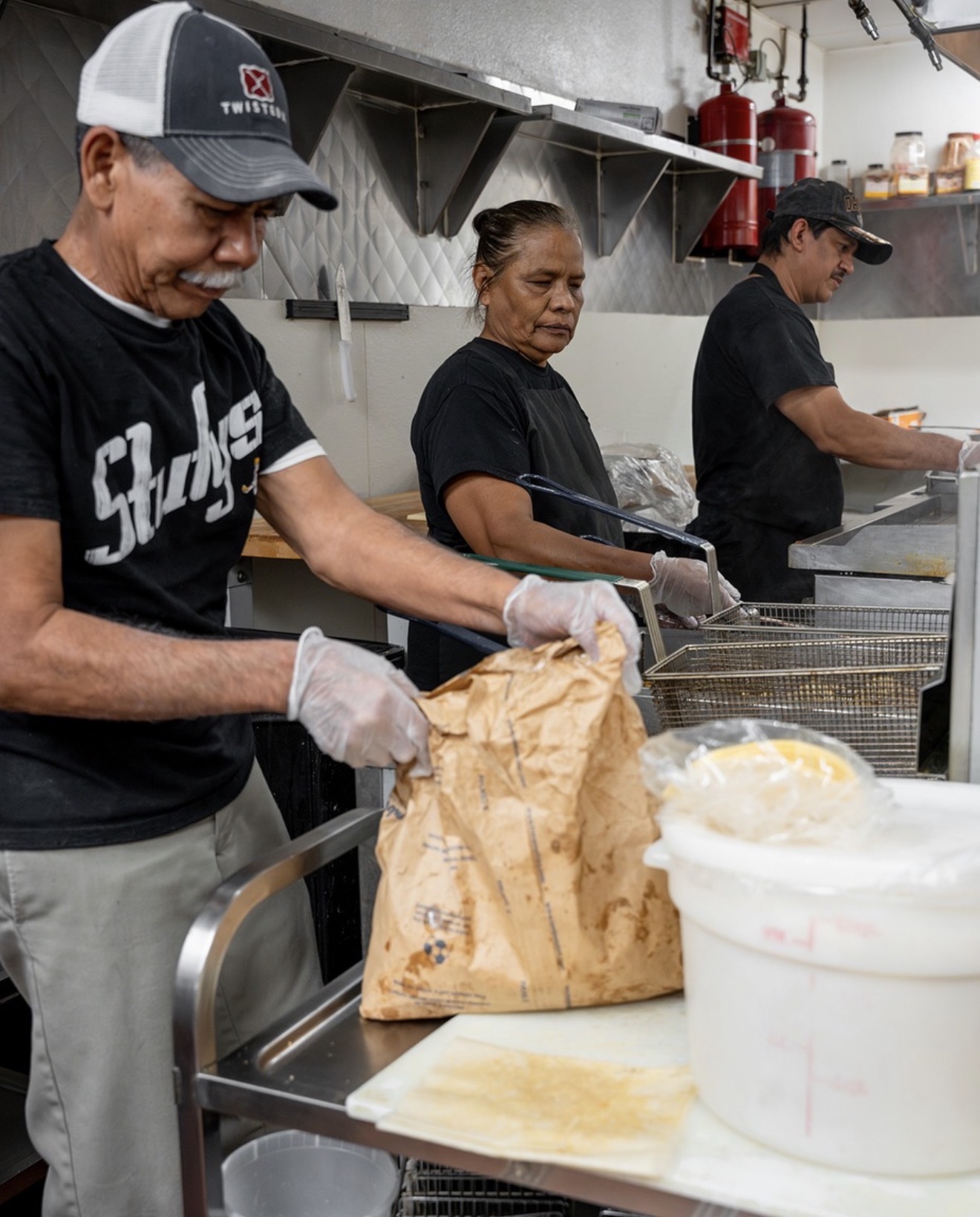 Stufy's kitchen team frying fresh sopaipillas and bagging orders together