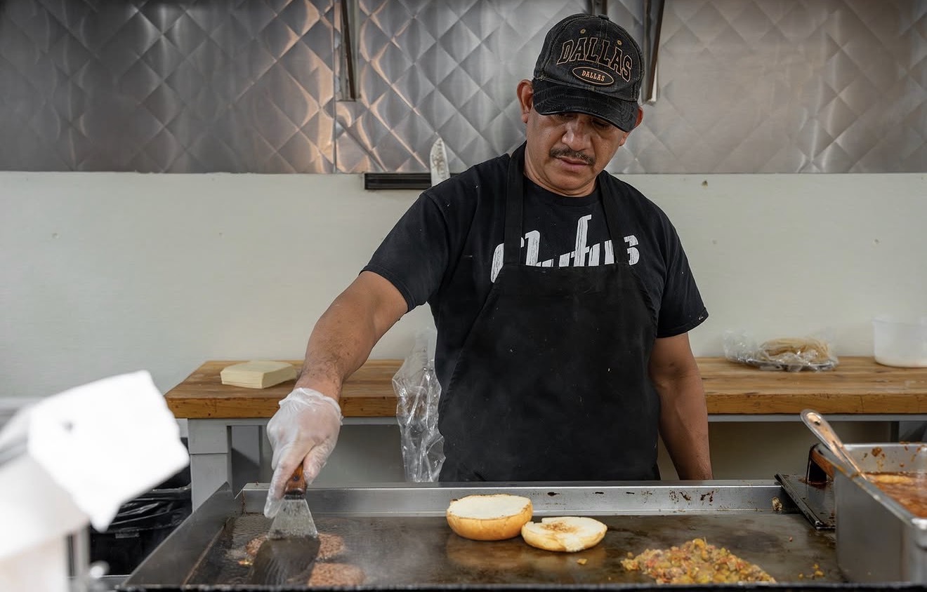 Stufy's cook searing green chile cheeseburgers on the flat-top griddle