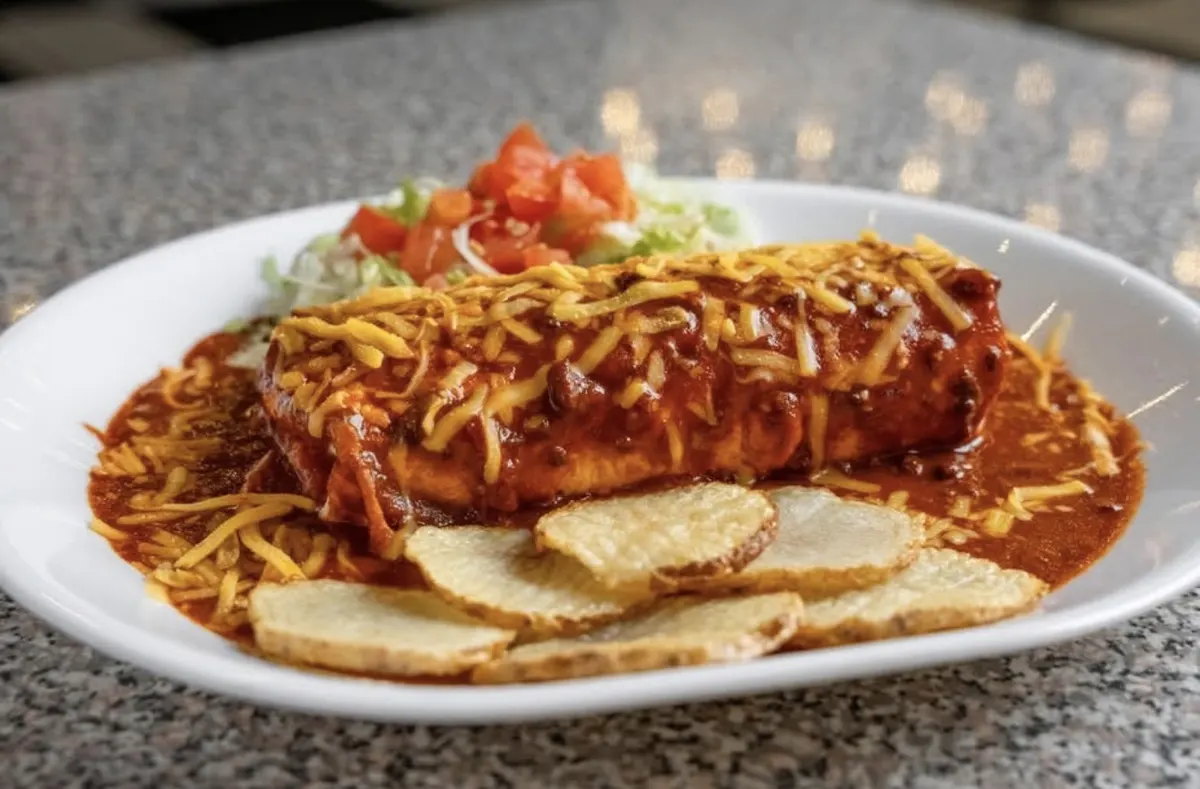 Stuffed sopaipilla smothered in red chile and cheese